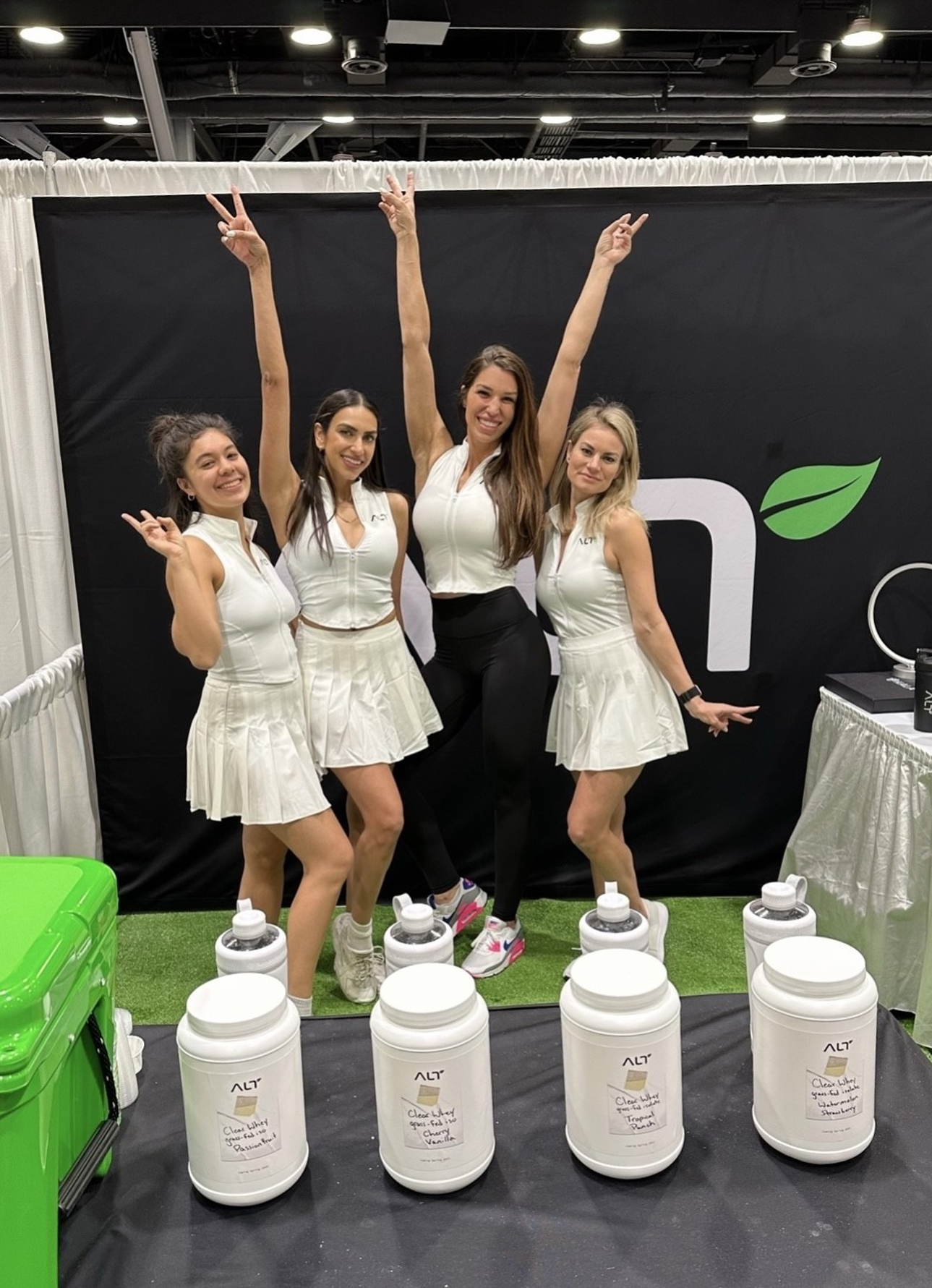4 women at trade show with alt products